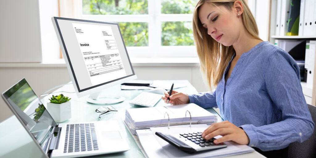 Woman sitting at table doing accounting work