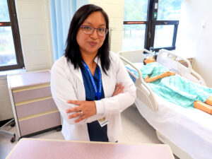 PCT student stands in nursing lab