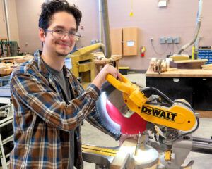Construction student with radial arm saw
