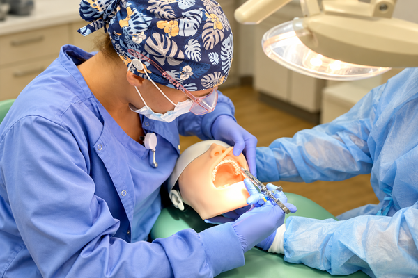 Dental dental student working on a simulation doll to practice dental lessons