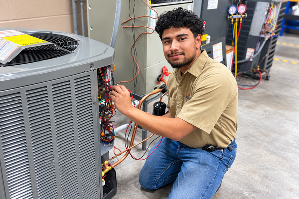 HVAC Air Conditioning Tech student working on an ac unit in class