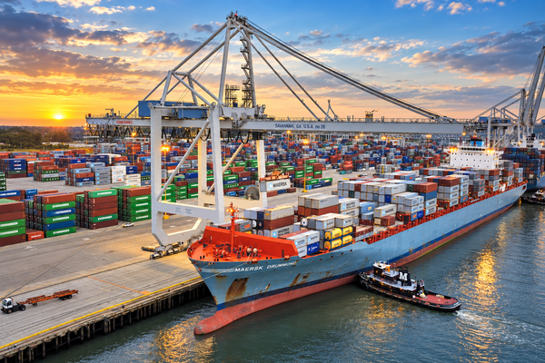Logistics_Supply_Chain Ship filled with shipping containers and the port on the Savannah River