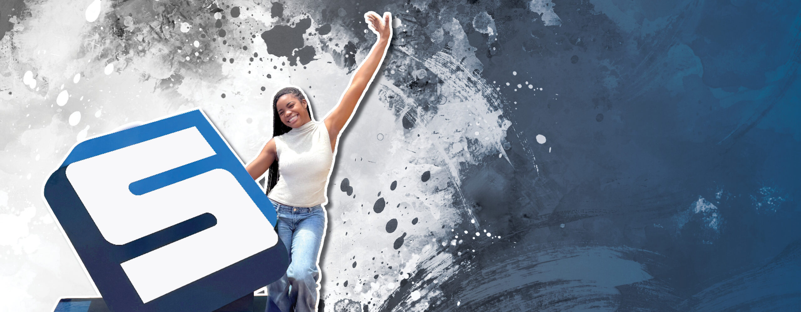 Female student standing beside the metal Savannah Tech S, smiling, one hand in the air