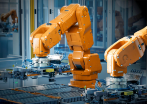 Automation and Robotics: Industrial robotic arms operate along an automated manufacturing line.
